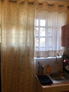 a kitchen with a window and a sink at Hornville suites in Ongata Rongai 