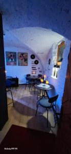 a room with tables and chairs in a room with a stone wall at B&B Lostallo Beat and Bloom in Lostallo