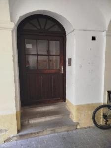 a wooden door with stairs in front of a building at All you need is Love1 in Bratislava