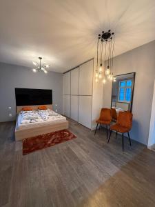 a bedroom with a bed and a table and chairs at All you need is Love1 in Bratislava