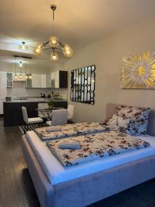 a bedroom with a large bed and a kitchen at All you need is Love1 in Bratislava
