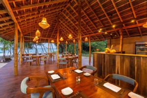 a dining room with tables and chairs in a restaurant at Arinna Beach Resort in Tangalle