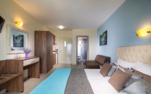 a bedroom with a large bed and a living room at Castro deluxe in Toroni