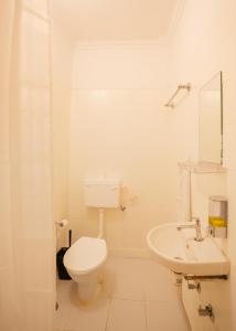 a white bathroom with a toilet and a sink at Hammock Hostels - Jaipur in Jaipur +77 photos