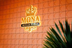 a neon sign for a mona miami first restaurant at Khách sạn Mona in Dĩ An