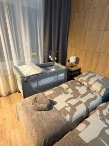 a bedroom with two beds and a sink in it at Villa Gold Poznań in Poznań