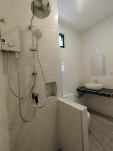 a bathroom with a shower and a toilet and a sink at Double Rock Beach Hotel in Thong Sala +69 photos