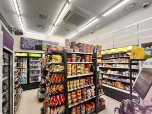 a store aisle of a grocery store filled with food at Sungsan Marina Hotel in Seogwipo +5 photos