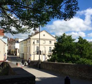 a group of people walking down a city street at The Town House at Brecon in Brecon