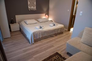 a bedroom with a bed with towels on it at Къща за гости В 12 и 5 in Dolna Banya