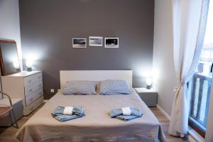 a bedroom with a bed with two pillows on it at Къща за гости В 12 и 5 in Dolna Banya