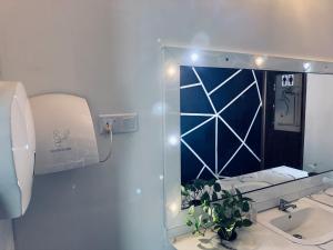 a bathroom with a mirror and a sink at New National in Pettah +3 photos