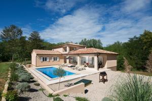 una casa con piscina frente a ella en Istrian Villa Happy House, en Nedeščina