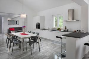 a kitchen and dining room with a table and chairs at Istrian Villa Happy House in Nedeščina