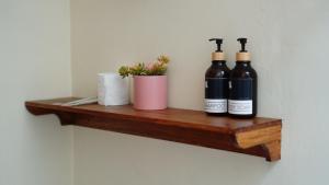 two bottles of wine sitting on a wooden shelf at Among Villa in Yogyakarta +22 photos
