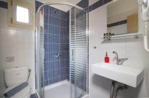 a bathroom with a shower and a sink and a toilet at Castro deluxe in Toroni +37 photos