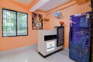a room with a refrigerator and a poster on the wall at Avinaav Inn in New Town