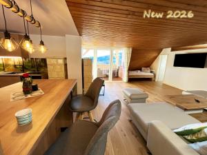 a kitchen and living room with a couch and a table at Almhütte Grosserhütte in Katschwald
