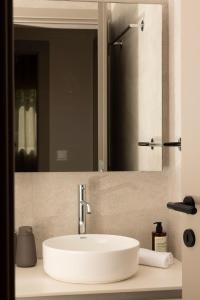 a white sink in a bathroom with a mirror at Pinewood by Holistays in İncirli