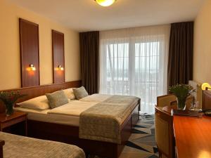 a hotel room with two beds and a window at PRIMAVERA Hotel & Congress centre in Pilsen +70 photos