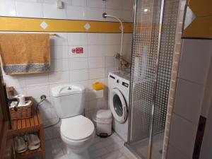a bathroom with a toilet and a washing machine at Στουντιο στο Πανοραμα in Thessaloniki +19 photos