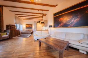 a living room with a couch and a table at BERCHY Apartments MAISON in Liepāja