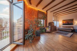 a living room with a brick wall and a large window at BERCHY Apartments MAISON in Liepāja
