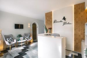 a lobby with chairs and a table in a room at Romantic Palace Beach Apartments in Agios Gordios