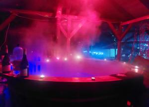 a stage with red and blue lights in a room at Aroa Mountain in Zărneşti
