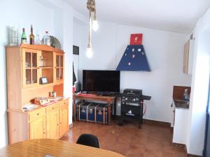 a living room with a table and a tv at Casa Palomar in Alcaudete