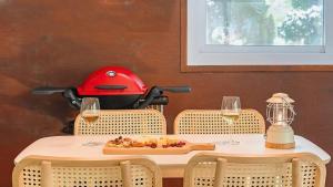 a table with a red helmet and a plate of food at Pocheon luxjay pet Pension in Pocheon