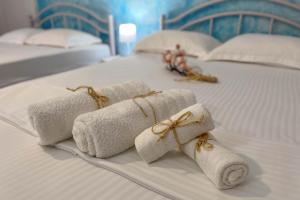 a group of rolled towels on a bed at Villa Leonidas in Nea Vrasna