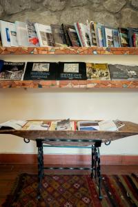 a wooden table with books on a shelf at Hotel Mirhav in Goris