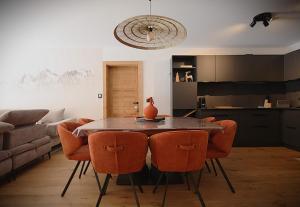 a kitchen and dining room with a table and chairs at La Moutonniere in Levassaix