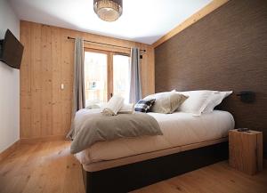 a bedroom with a large bed with a window at La Moutonniere in Levassaix +18 photos