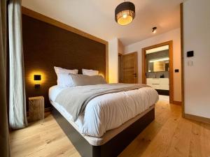 a bedroom with a large bed with a large headboard at La Moutonniere in Levassaix