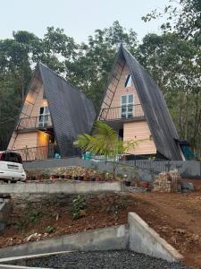 a house with two pointed roofs on top of it at Zerahs Private Pool Villa, Athirappilly - Extra upstair Bed space in Athirappilly