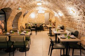 a restaurant with tables and chairs and a brick wall at Moris Grands Boulevards in Paris