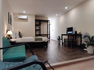 a living room with a bed and a desk at Catba Garden Camellia in Cat Ba
