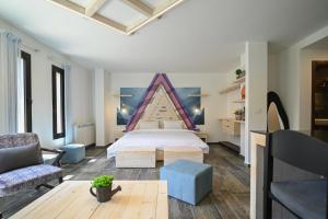 a bedroom with a bed and a couch and a table at Arawan - Boutique Art Hotel - Tannourine in Batroûn +84 photos