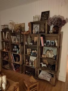a room with a book shelf filled with lots of items at Le Flow de Ginette in La Celle-sous-Gouzon