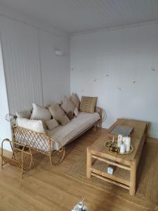 a living room with a couch and a coffee table at Le Flow de Ginette in La Celle-sous-Gouzon