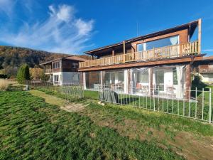 a large house with a fence in front of it at Villa Nikol Apartment #4 in Raduil