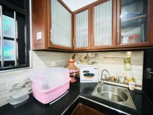 a small kitchen with a sink and a pink container at Sasanda Villa in Weligama +28 photos