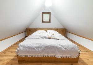 a bedroom with a bed in a attic at Glamping Podgoro with private hot tube - Rogatec in Rogatec