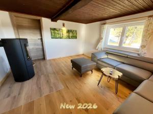 a living room with a couch and a table at Almhütte Ödenhübl in Katschwald