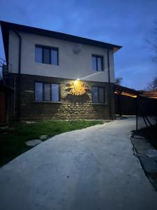 a house with a light on the side of it at Han Gozdeika in Gozdeyka