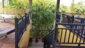 a railing on a porch with a bench and plants at Villa Rustic in Negombo +6 photos