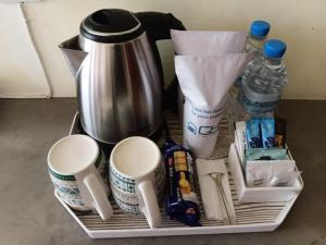 a tray with a coffee maker and some drinks at Villa Rustic in Negombo