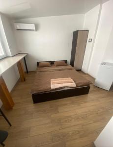 a bedroom with a bed and a desk at Студія в центрі міста , 7 поверх без ліфту in Ivano-Frankivsk